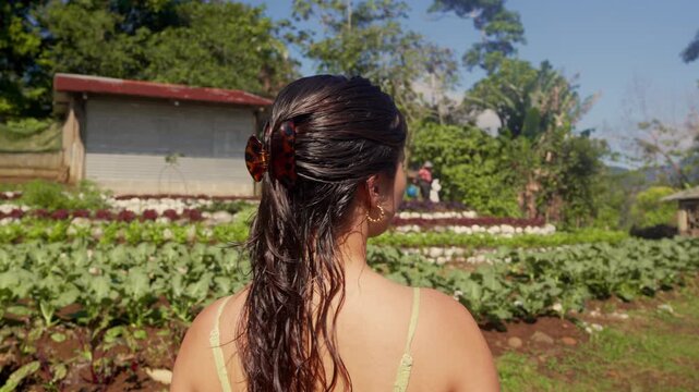 Individual standing in front of a beautiful organic farm