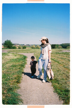 Mother and toddler stopping in a meadow during a road trip