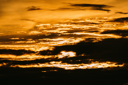 Sunset with clouds and golden light over the horizon