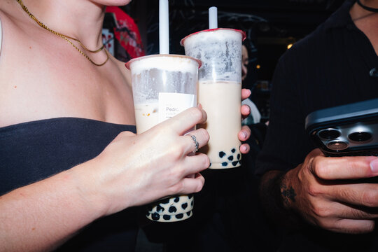 Friends holding bubble tea drinks connecting socially