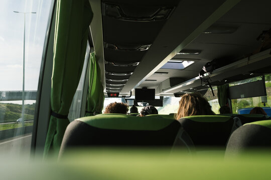 View from inside a bus traveling on a highway in daylight