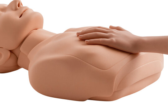 Hand performing chest compressions on CPR training manikin for resuscitation first aid and BLS training