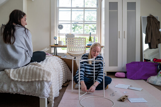 Teenage girl building flatpack furniture