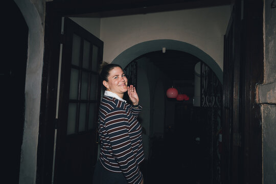 Woman smiling walking into a restaurant