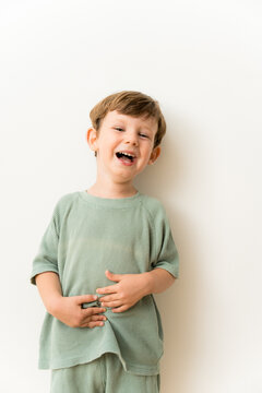 A toddler laughing while having fun at home