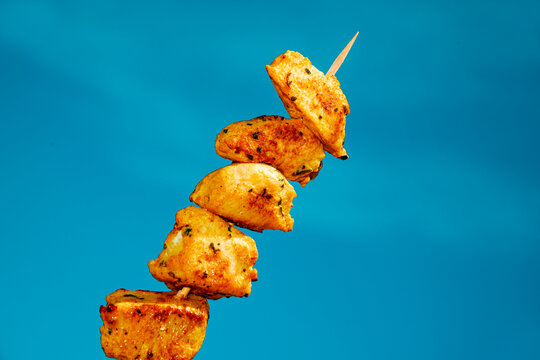 a traditional spanish pincho moruno skewer against the sky