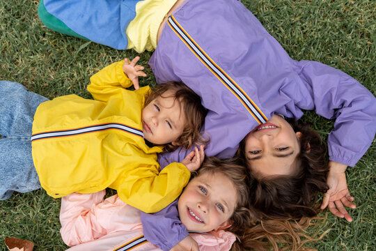 Children lying together on grass