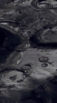 The surface of Mars shows circular patterns with dark and light areas. The view is taken from orbit, revealing landscape details and textures that define the planets surface.