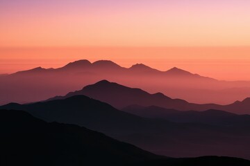 Obraz premium Calm horizon with dark mountain silhouettes and warm sunset tones