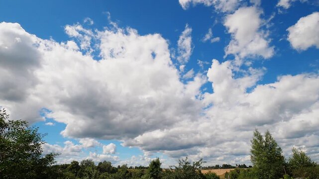 Sunny Summer Sky With Large White Cumulus Clouds Drifting Across Blue Background, Nature Weather Timelapse