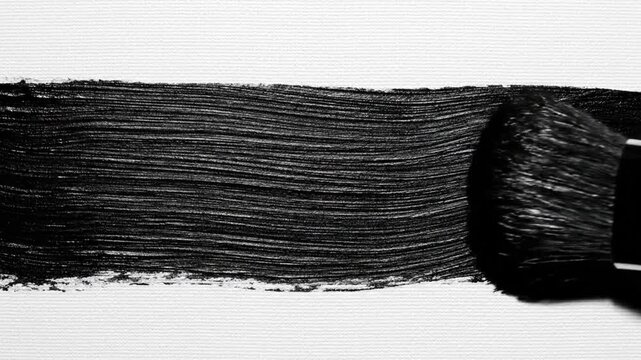 A black brush stroke painted on a white paper texture frame by frame sequence