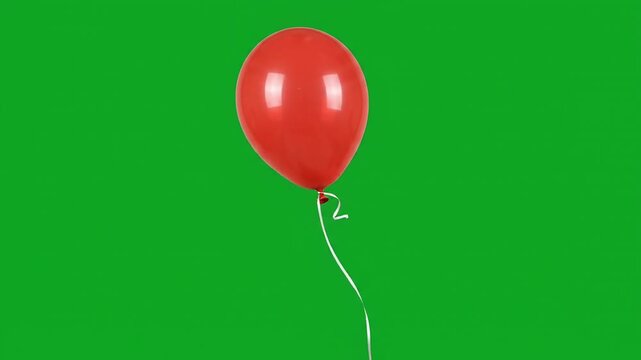 Red glossy balloon with ribbon swaying gently on green screen