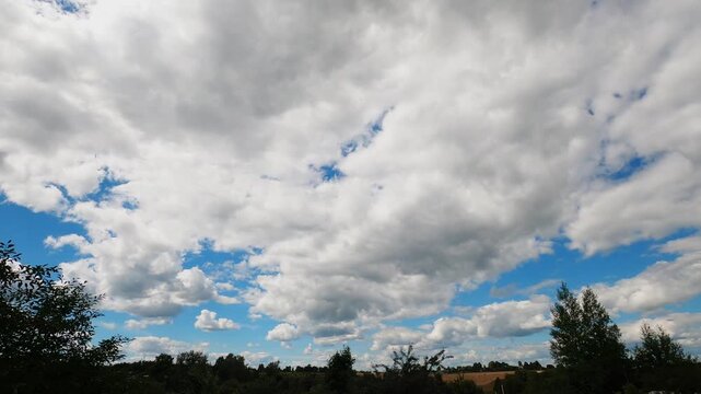 Bright Summer Day With Fluffy White Cumulus Clouds Moving Across Clear Blue Sky, Dynamic Weather Timelapse