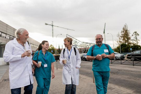 Medical professionals walking outdoors during a coffee break