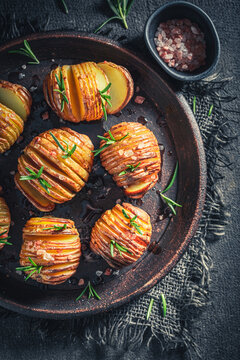 Freshly baked Hasselback potatoes with fragrant rosemary and salt.