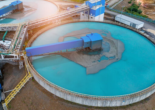 Aerial view Industrial water treatment facility with sedimentation tanks pulp in copper and gold mining factory, sunlight