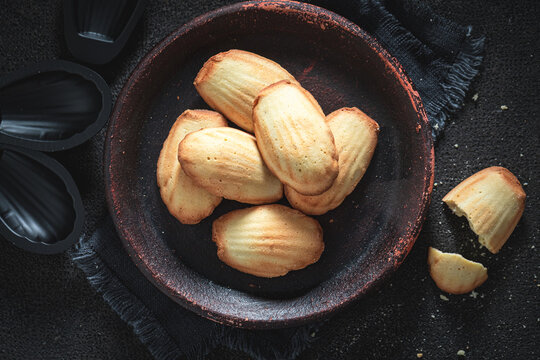 Classic Madeleine cookies featuring flour, eggs, sugar, and butter.