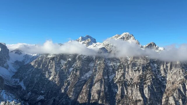 Julian Alps winter landscape - trail to Debela pec peak in Triglav national park, and view on Triglav