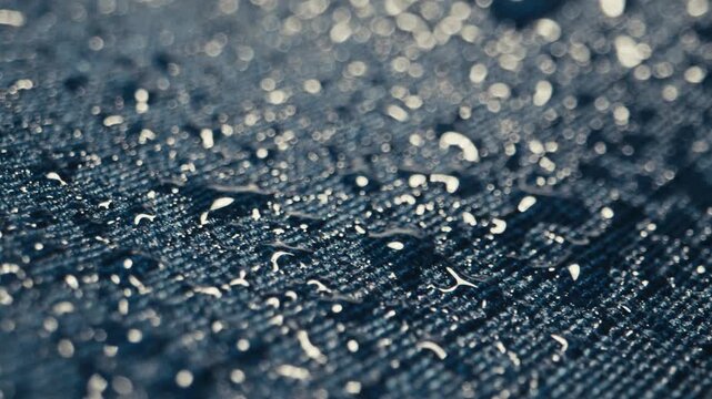 Fabric waterproof jacket hiking close up rain drops texture outdoor material macro detail