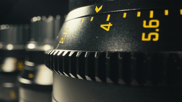 Camera operator working with cinema macro lens on film set behind the scenes production