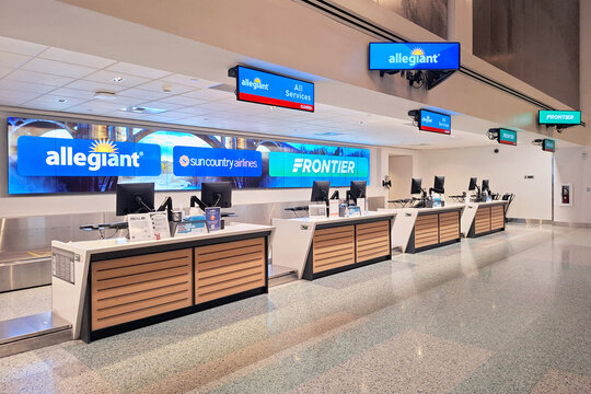 Ultra low cost carriers Frontier Airlines, Allegiant Air, and Sun Country Airlines airport ticket counter at Spokane Int'l Airport, showcasing budget airline travel, and affordable airfare