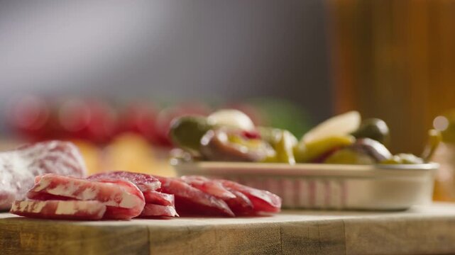 Mix of spanish pork sausages, Cutting board of appetizing catalonian snack - fuet, jamon, chorizo, olives, supermarket tapas food in spain, traditional cuisine. 