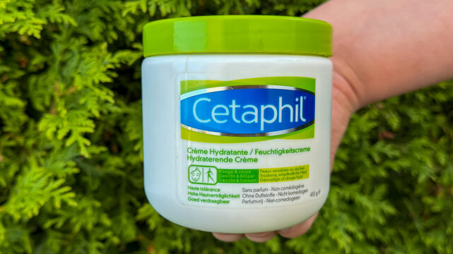 Holding cetaphil moisturizing cream for healthy skincare