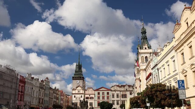 Historic city square in Pardubice Czech Republic features ornate European architecture a clock tower colorful facades and white clouds under a bright blue summer sky view