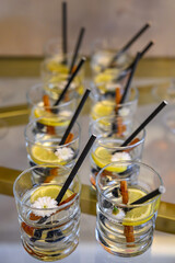 specialized holiday-themed cocktails featuring lemon slices, mint, cinnamon sticks, and small white flowers. © nedomacki