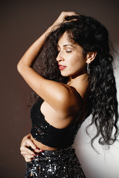 Portrait of caucasian woman salsa dancer under a projector's light