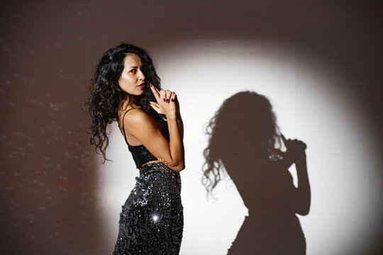Portrait of caucasian woman salsa dancer under a projector's light