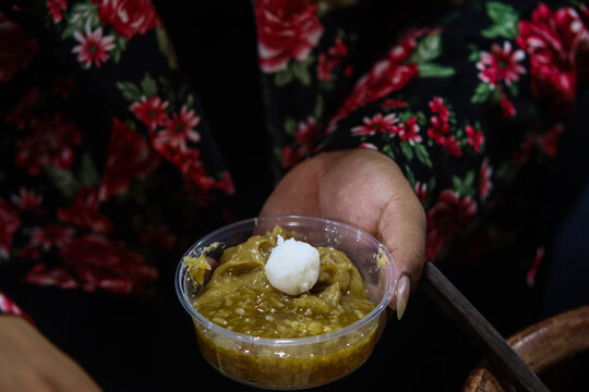 Vendor Placing Single Rice Flour Ball Gempol on Top of Sweet Palm Sugar Porridge