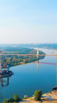 Vertical video. Murom, Russia. Construction of a bridge across the Oka River. Highway M-12 Moscow-Nizhny-Novgorod-Kazan. Drone footage, Point of interest. Rich colors