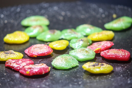 Colorful Red Green Yellow Kipo Glutinous Rice Cakes Grilling on Flat Hot Pan