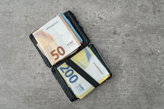Euro banknotes in a wallet. A thick roll of Euro banknotes.
