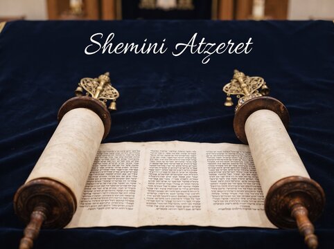 An open Sefer Torah scroll resting on a deep blue velvet cloth with the words Shemini Atzeret written above, representing the Jewish holiday marking the conclusion of the High Holy Days.