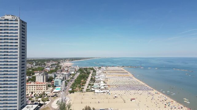 Aerial drone view of historic Porto Canale Leonardesco harbor lined with colorful boats, traditional houses and Adriatic coastline in Cesenatico, Emilia-Romagna, Italy