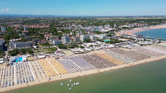 Aerial drone view of historic Porto Canale Leonardesco harbor lined with colorful boats, traditional houses and Adriatic coastline in Cesenatico, Emilia-Romagna, Italy