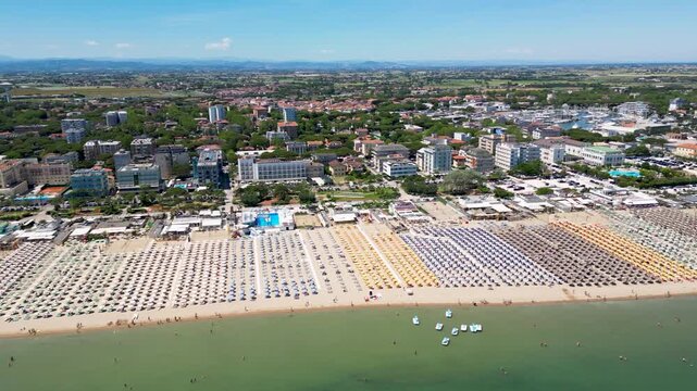 Aerial drone view of historic Porto Canale Leonardesco harbor lined with colorful boats, traditional houses and Adriatic coastline in Cesenatico, Emilia-Romagna, Italy
