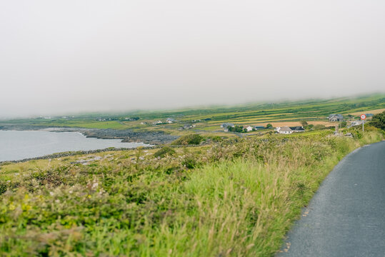 The Burren, County Clare, Ireland - August 23, 2026. Unique limestone landscape characterized by rugged rock formations, exposed limestone pavements, green fields, and dramatic scenery along the Atlan