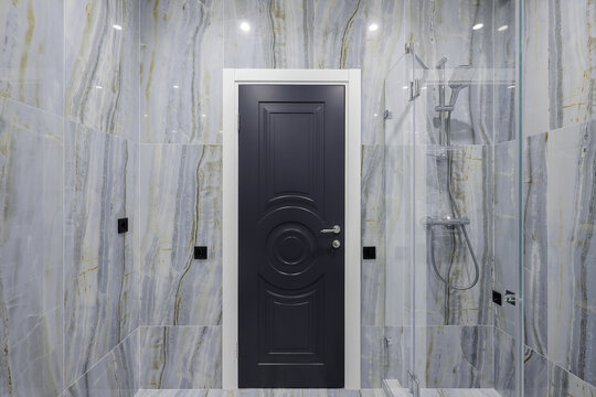 Black bathroom door marble walls
