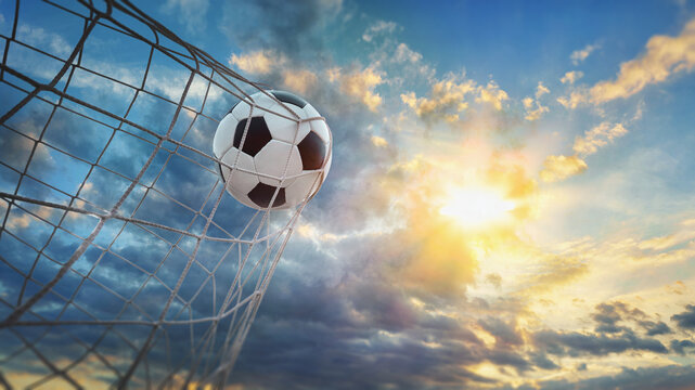  Soccer ball in soccer goal net . Close-up textured soccer net on soccer goal isolated on blue sky background.