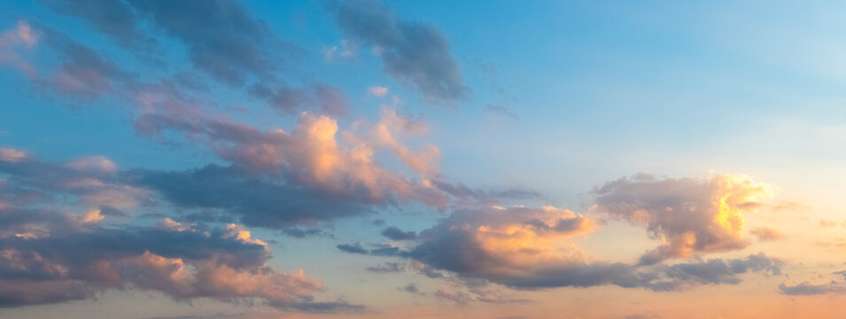 Pink clouds in blue sky during sunset panoramic view