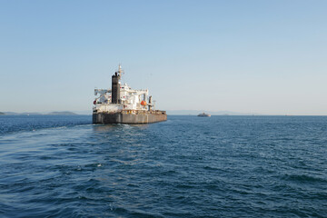 Fototapeta premium cargo ship leaving the port to sea