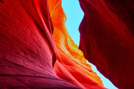 Vibrant Slot Canyon Colors &ndash; Sunlit Sandstone Curves Opening Toward Blue Sky