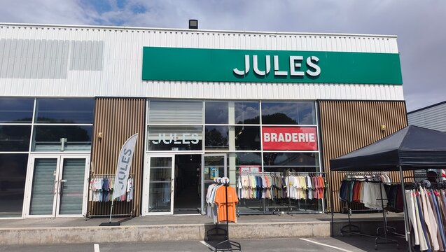 Royan, France - August 10, 2026: New Aquitaine, Charente-Maritime, Centre commercial. Jules clothing store exterior with display of shirts and promotional banner in shopping center