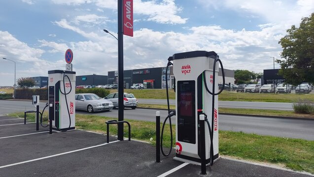 Royan, France - August 10, 2026: New Aquitaine, Charente-Maritime, Centre commercial. Electric vehicle charging stations at Avia in commercial area with parked cars and clear sky