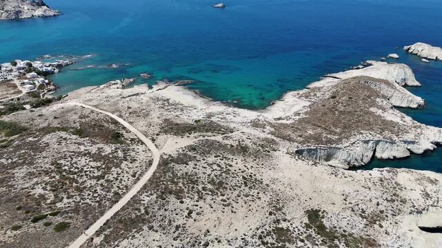 Drone aerial view over the Aegean sea in the village of Mandrakia on the Greek island Milos in Greece. 