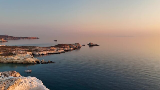 Aerial drone view over Mandrakia village near Sarakiniko beach on the Greek island Milos in Greece during sunrise. Unique rock formations of the coastline. 