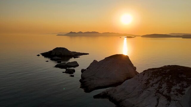 Aerial drone view over Mandrakia village near Sarakiniko beach on the Greek island Milos in Greece during sunrise. Unique rock formations of the coastline. 